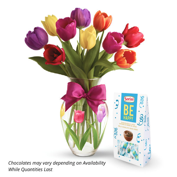 Colorful tulips in vase with chocolates